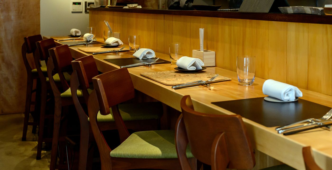 Wooden omakase counter with place settings