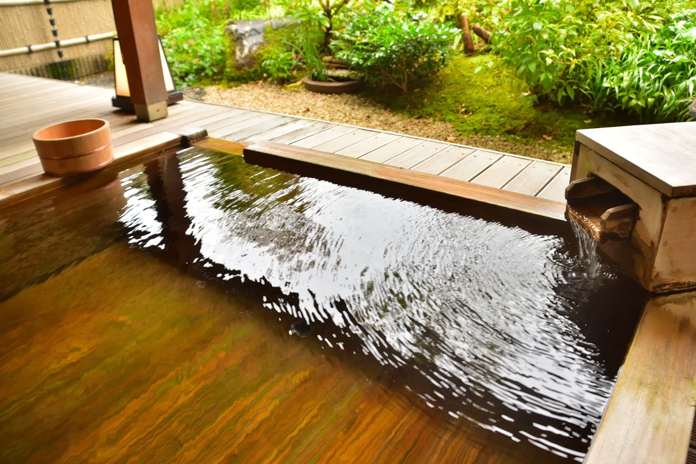 Wooden open-air bath with flowing water